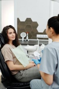 A dentist and patient in a modern clinic during a dental consultation.